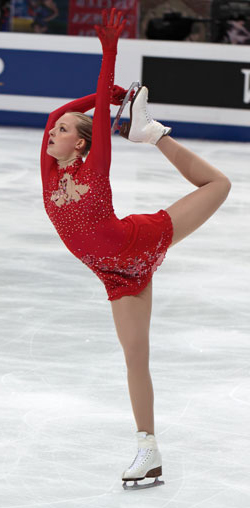 young female figure skate in full extension